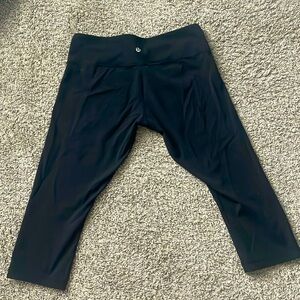 Black lululemon 3/4 length athletic yoga pants.